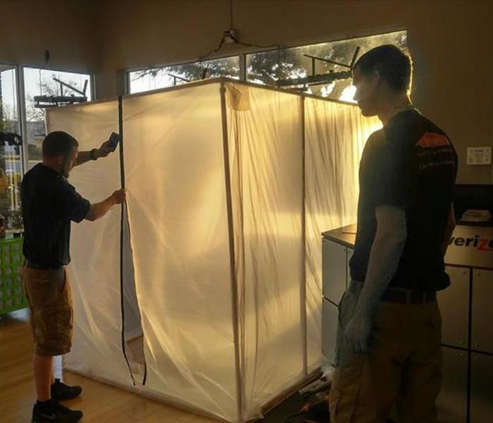 Crew putting up containment at a mold job.